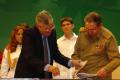 Raul Castro Ruz browses photo book given to Fidel for the first graduation of engineers in computer science, Karl Marx Theater July 19th, 2007.